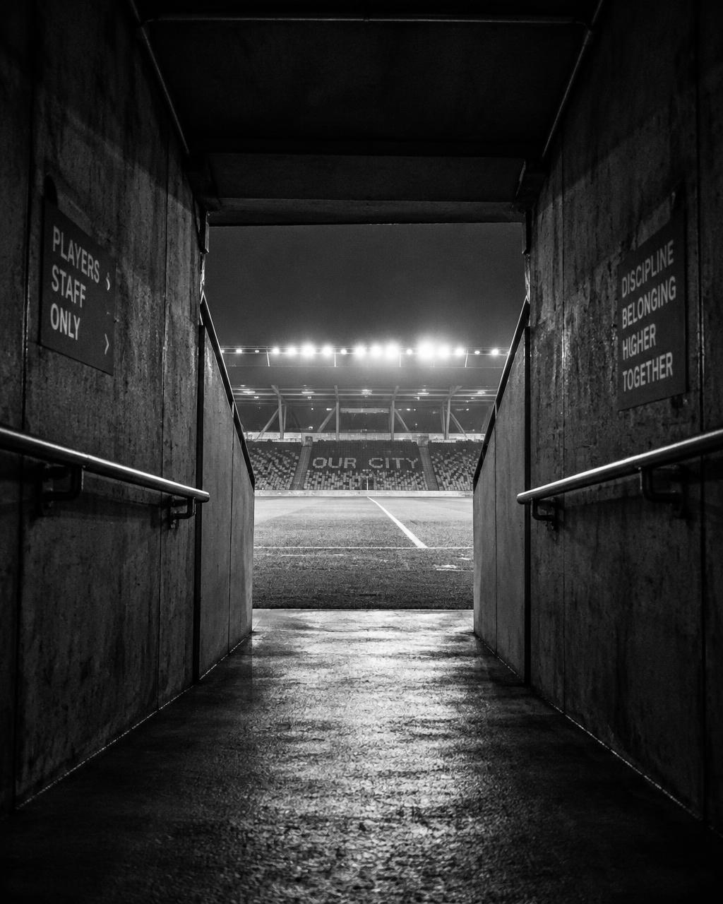 A players' tunnel opening onto a stadium pitch